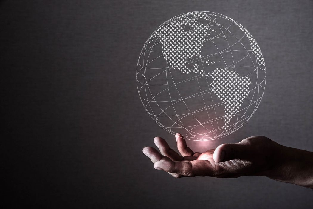 business person holding a globe